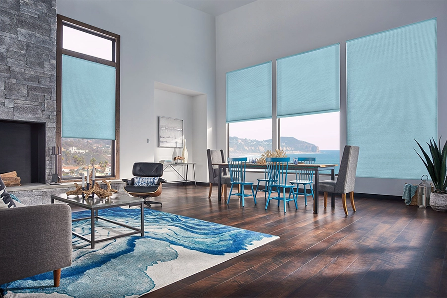 Smart motorized window shades are perfect on tall windows in your Southern California home. Blue motorized shades on tall living room windows